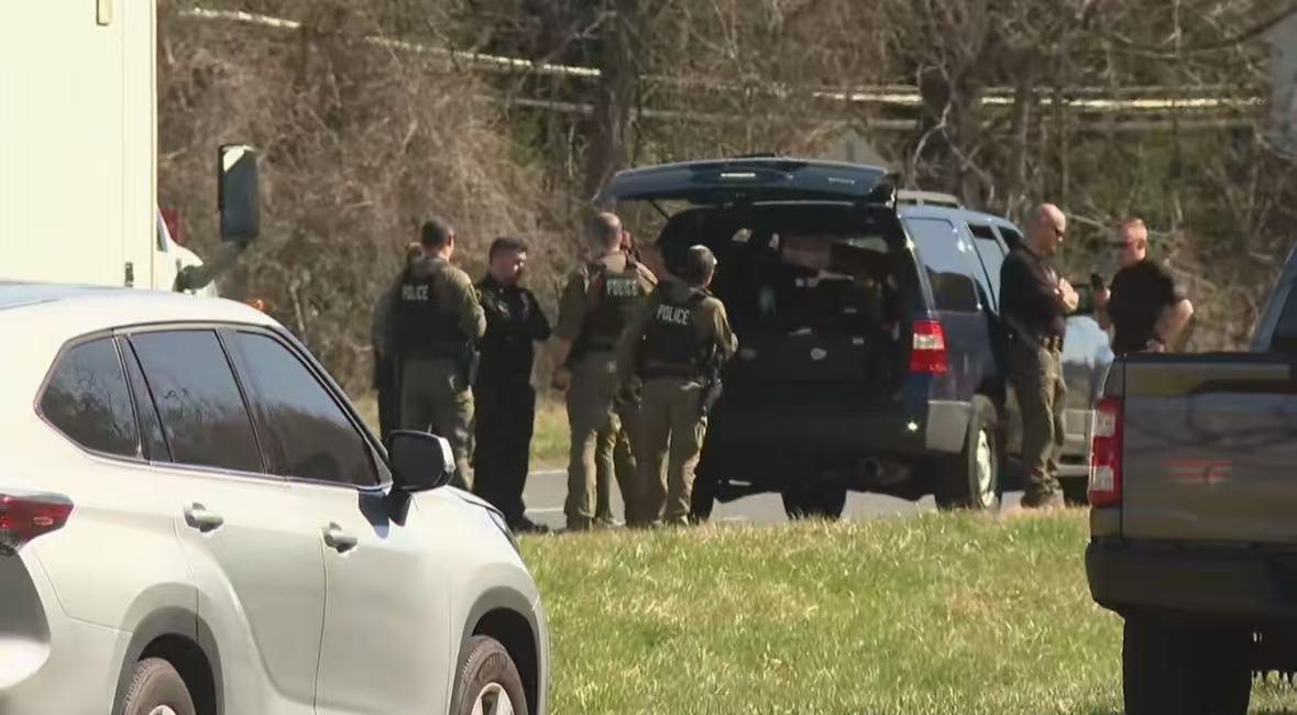A man holding a gun poses a threat outside the CIA headquart
